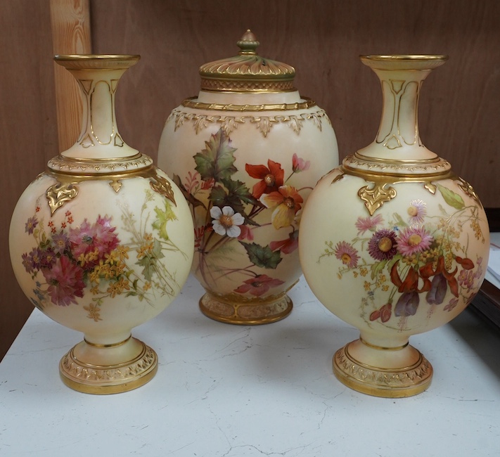 A Worcester blush ivory jar and cover, and a pair of similar vases, shape numbers 2048 and 1851, tallest 26cm. Condition - good